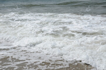 Foam sea wave running ashore