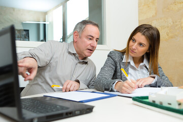 female and male architect talking in his office