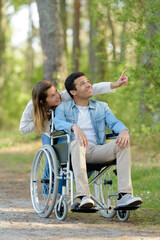 couple with wheelchair in autumn nature