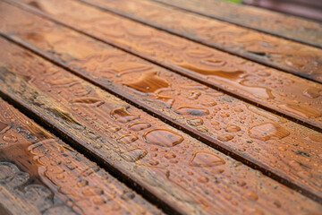 Wet wooden garden table after rain