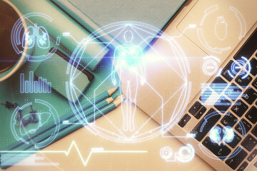 Education hologram drawings over computer on the desktop background. Top view. Multi exposure.