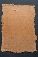 This is craft cardboard with jagged edges for advertisements or recordings on a black background.