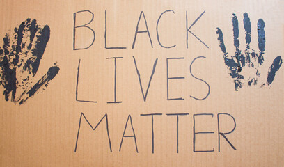 BLACK LIVES MATTER. Text message for protest on cardboard. Stop racism. Police violence. Banner design concept.