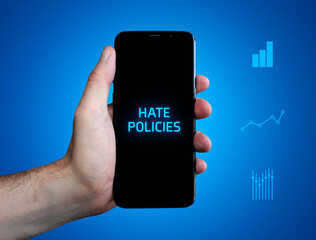 Hate policies. Hand holds phone (cell phone). Word on display. Charts on blue background. Business