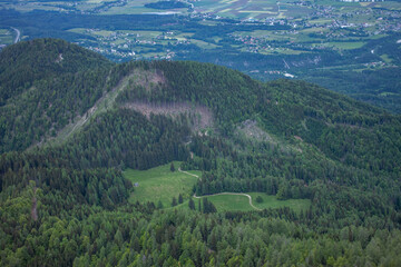 hills covered by different green grass and forest
