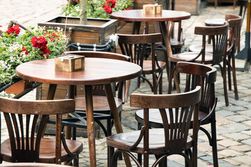 Fototapeta na wymiar empty table patio cafe on the street wooden furniture without people here landscape environment