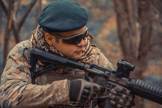 portrait of a soldier with a gun in the forest of Battlefield/army uniform with a weapon.
