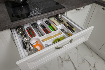 Kitchen drawer with content visible opened