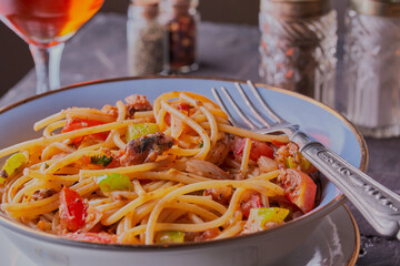 Pasta and sardines with vegetables in tomato sauce.