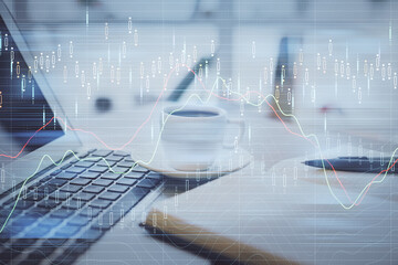 Double exposure of financial chart drawing and desktop with coffee and items on table background. Concept of forex market trading