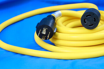 Yellow electric cable on  blue background, selective focus