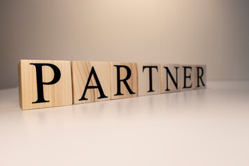Partners word written on wood block. Partners text on wooden table.