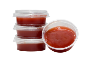 Tomato ketchup in plastic tubs isolated on white background.
