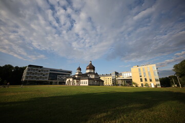 A large building with a grassy field