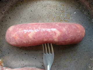a fork holding sausage