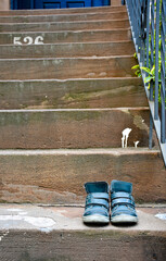 Kids shoes on a brownstone stoop Brooklyn New York City 