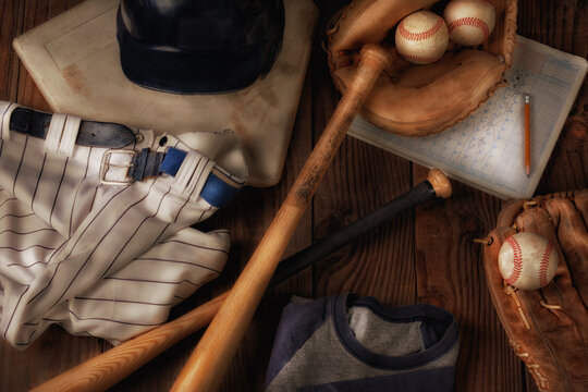 Flat Lay Baseball Still Life with warm sde light. Overhead view of baseball gear on a rustic wood surface.