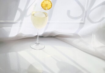 Limoncello or white wine in transparent long glass