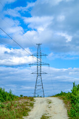 Obraz premium Power pole with wires against the blue sky. The correct form of metal construction