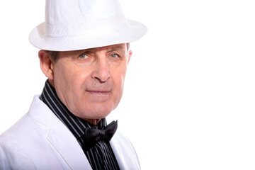 Attractive elderly man dressed in white with hat and elegant style