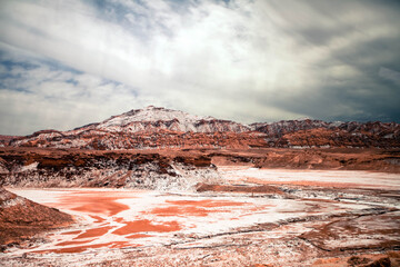 The pink and white riverbed in Atacama desert with red hill in the background and beautiful clouds above #2