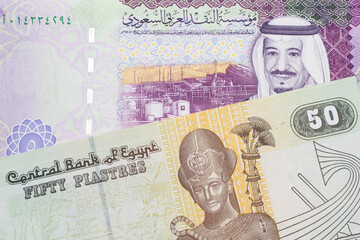 A close up image of a colorful fifty Egyptian piastres note close up in macro with A colorful, five Saudi riyal bank note