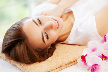 Fototapeta na wymiar Young woman on rejuvenating facial massage in beauty studio
