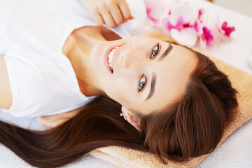 Obraz na płótnie Canvas Young woman on rejuvenating facial massage in beauty studio