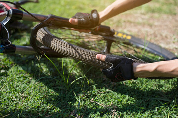 Bicycle tires leak, Cyclists are checking bicycle wheels, Close-up
