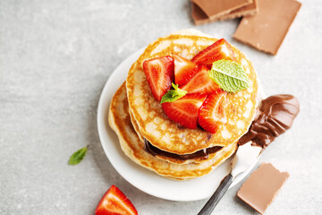 Freshmade pancakes served with strawberry and choco paste