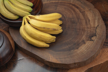 close up bunch of bananas with wooden trunk background, normal appearance