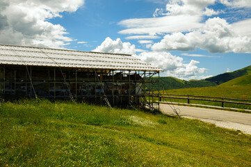 The small church of the Madonna della Cona, near Castelluccio di Norcia, surrounded by reinforcement structures to remedy earthquake damage.
