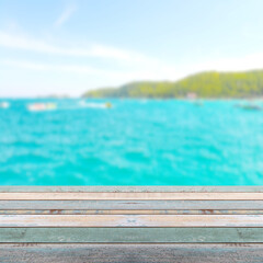 Naklejka na ściany i meble Wood table top with blurred nature scene tropical beach