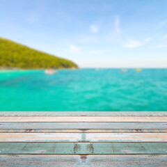 Fototapeta premium Wood table top with blurred nature scene tropical beach
