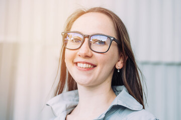 Portrait of a young beautiful caucasian girl in glasses.