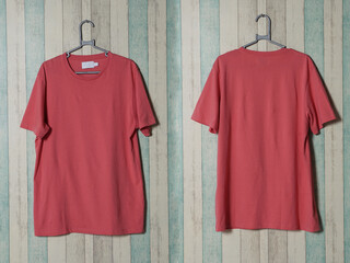 Pink shirt hanging on the wall. Exclusive hanger with empty pink t-shirt hanging isolated. Blank...