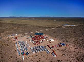 Vaca Muerta, Argentina, December 23, 2014: Extraction of unconventional oil. Battery of pumping trucks for hydraulic fracturing (Fracking).