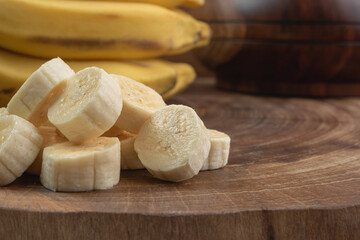 close up of sliced banana on rustic wood, with natural lighting