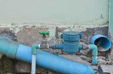 Fototapeta na wymiar Water meter and valve with sewage pipes