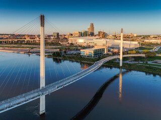 Bob Kerry Pedestrian Bridge spans the Missouri river with the Omaha Nebraska skyline in the...
