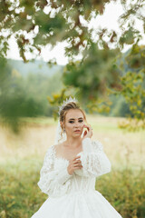 Fototapeta na wymiar Gorgeous beauty young bride portrait outdoor. Beautiful bride with wedding makeup and jewelry