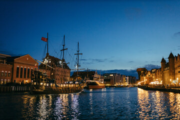 A boat is docked next to a body of water