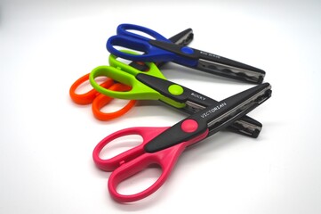 Assortment of scrapbook scissors on a white background
