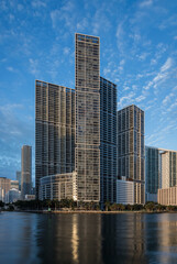 Fototapeta na wymiar Miami, FL/USA - 06/20/2020: Icon Brickell luxury apartments towers lit by golden morning light. 