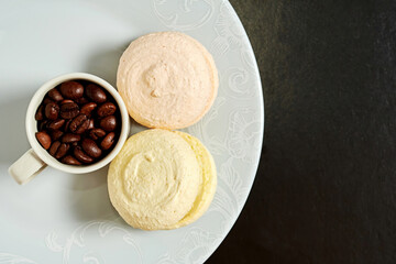 Macaroons and coffee mug on the plat baked for breakfast. Flat lay template with copy space for the text of your advertisement