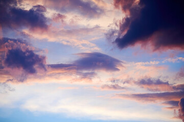Lush cloudy sky in the sunrise lights. Vivid colors of nature and atmosphere. Sunlights through clouds