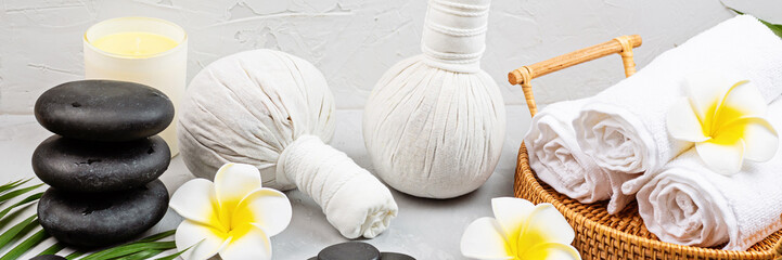 Spa massage Aromatherapy body care background. Spa herbal balls, cosmetics, towel and tropical...