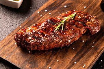 Fresh grilled meat. Grilled beef steak medium rare on wooden board. Top view.