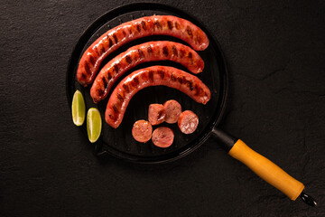 Fresh grilled Pepperoni sausage. Grilled Pepperoni Sausage on black pan.