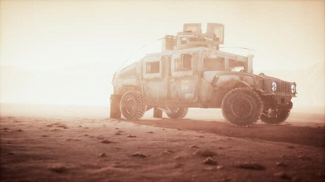 Military patrol car on sunset in desert storm